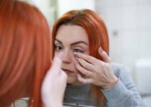 Girl applying contact lenses for improved vision