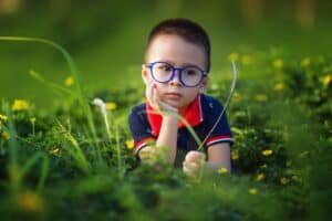 Child wearing glasses in need of myopia management, showcasing effective eye care.