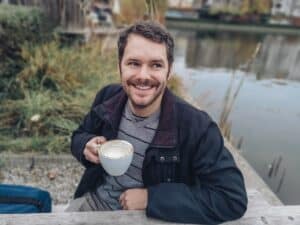 Man enjoying coffee outdoors, living with keratoconus