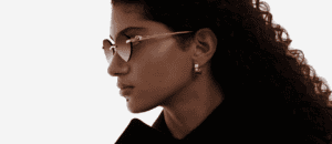 Woman wearing Cartier eyeglasses, showcasing luxury frames available in NYC.