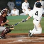 Baseball player wearing sports vision contact lenses hitting a home run